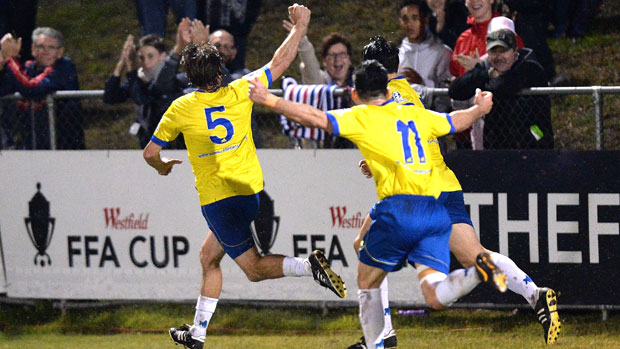 Greig Henslee races away to celebrate after giving Brisbane Strikers the lead against Melbourne City.