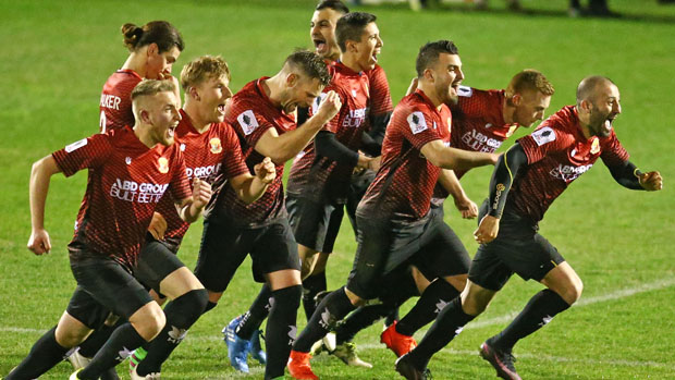 Hume City players celebrate their shootout win over Marconi.