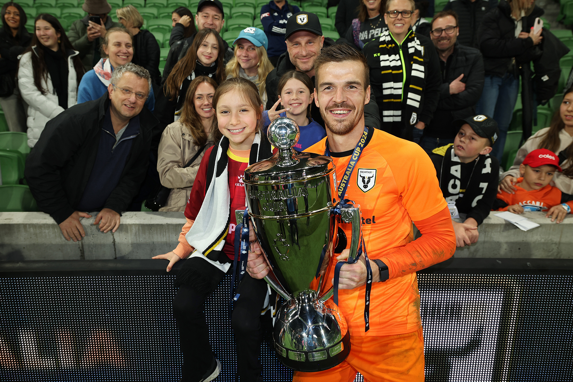 Macarthur FC goalkeeper Filip Kurto celebrates with the trophy after winning the 2024 Australia Cup Final match between Melbourne Victory and Macarthur FC at AAMI Park on September 29, 202