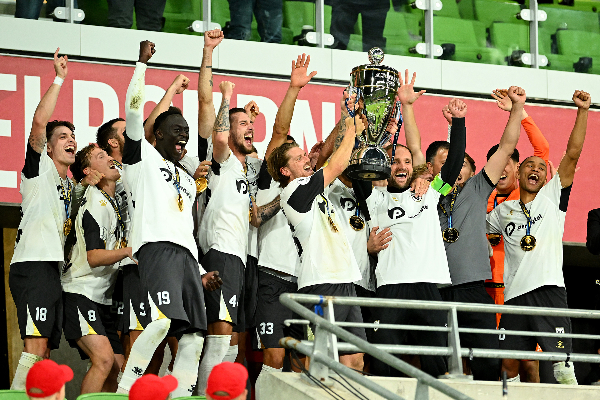 Macarthur FC hold the trophy aloft after winning the 2024 Australia Cup Final match between Melbourne Victory and Macarthur FC at AAMI Park on September 29, 2024