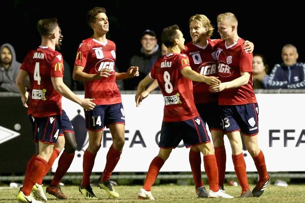 Adelaide United players celebrate Jordan Elsey's goal.