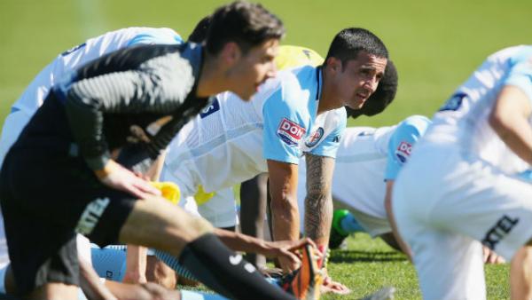 Tim Cahill warms up on the training ground with his Melbourne City teammates.