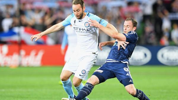 City defender Josh Rose fights for the ball with Victory midfielder Leigh Broxham.
