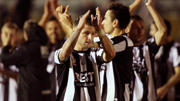 Adelaide City players celebrate after springing a Cup upset on the Wanderers.