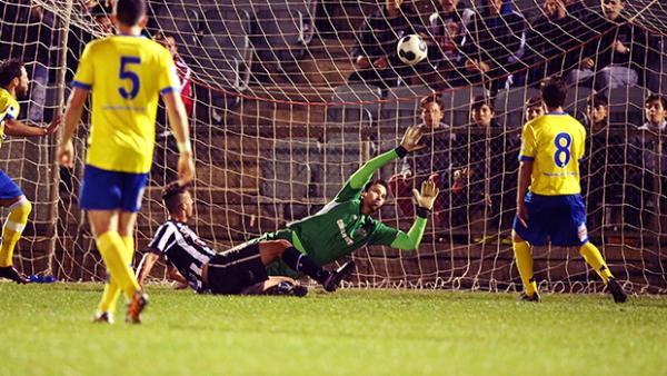 Adelaide City's Anthony Costa gets the ball past Strikers goalkeeper Michael Turnbull.