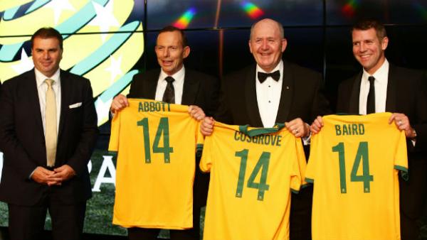 Prime Minister Tony Abbott, Governor-General Sir Peter Cosgrove and NSW Premier Mike Baird are presented with Socceroos jerseys by Coach Ange Postecoglou.