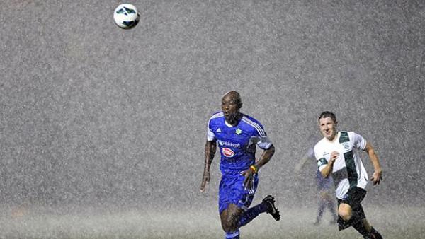Lloyd Owusu chases down a ball in torrential rain at Hensley Athletic Field.