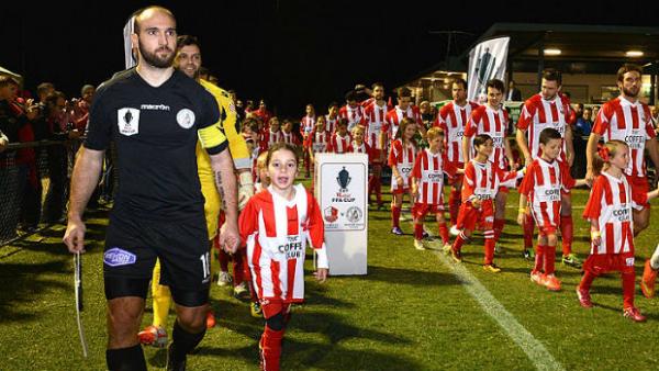 Former Melbourne Knights skipper Marijan Cvitkovic leads his side out against Olympic FC in the inaugural FFA Cup Round of 32.